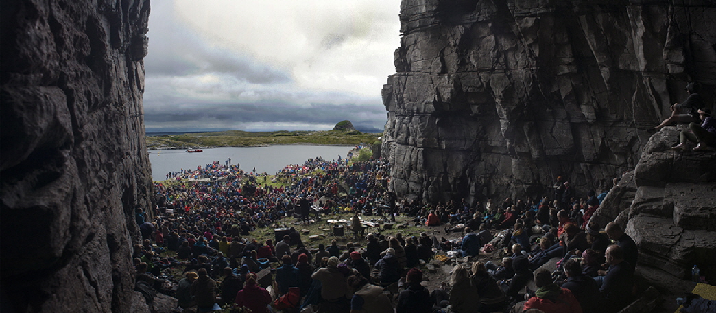 Pop artist RY X (Australia) performs before a huge crowd in what is known as the Cathedral Cave.   The size of the venue dwarfs everything around it.